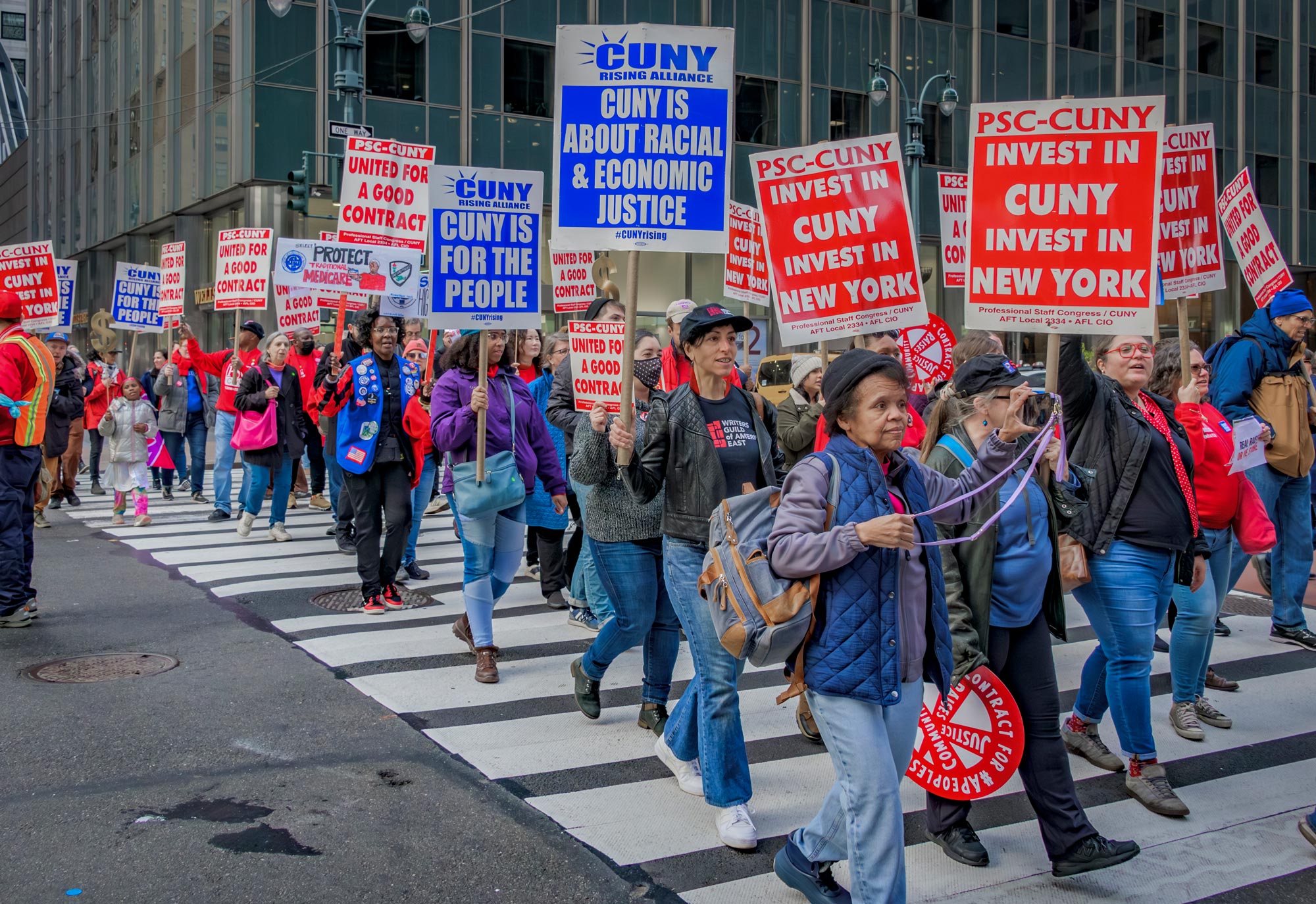Members marching to CUNY headquarters, to demand a contract with CUNY that lifts pay for faculty and staff and for part-timers and full-timers. (Credit: Erik McGregor)