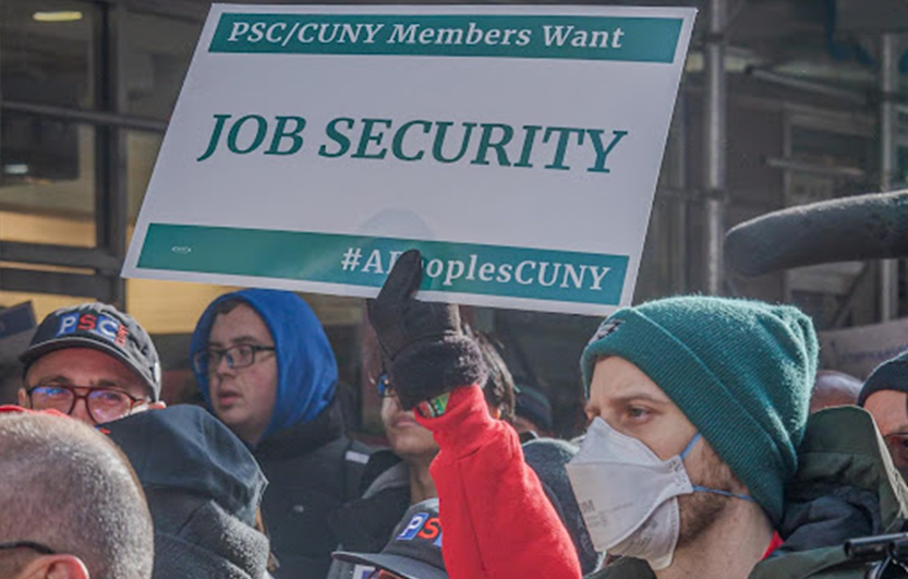 Image of PSC member holding up sign that reads: PSC/CUNY members want Job Security