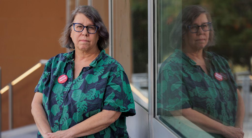 A faculty member wearing a red Union Proud psc button