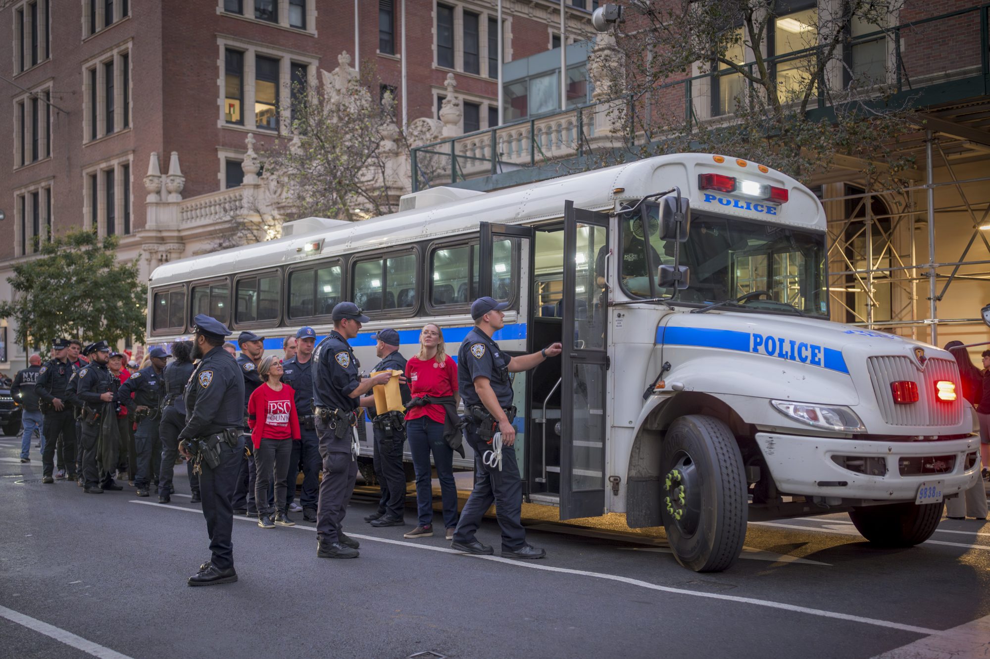 More than 30 faculty and staff of the City University of New York were arrested on October 21, 2024 during a union protest blocking the 10th Avenue entrance to CUNY’s John Jay College during a hearing of the Board of Trustees and refused to move demanding management to make an offer that would ensure real raises for workers and a quality college education for students. Hundreds more CUNY faculty and staff, students, and labor allies chanted “Real Raises! Job Security! Contract Now!” during the blockade. (Photo by Erik McGregor)